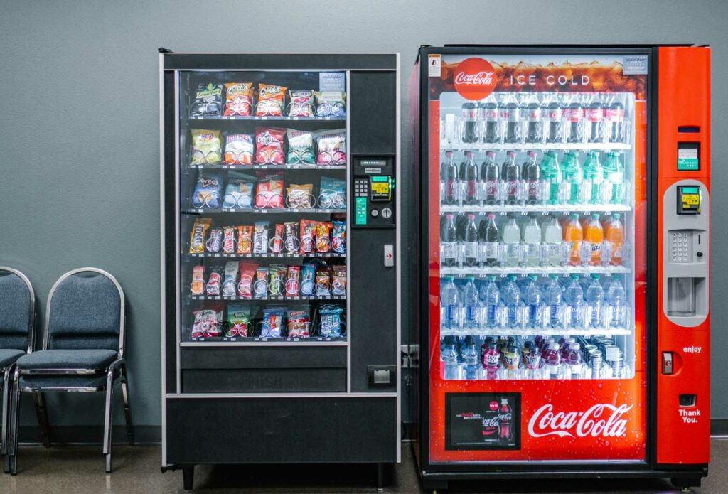 Vending machine regulations UK showing a compliant vending machine with allergen information food hygiene sticker and contactless payment in a UK workplace