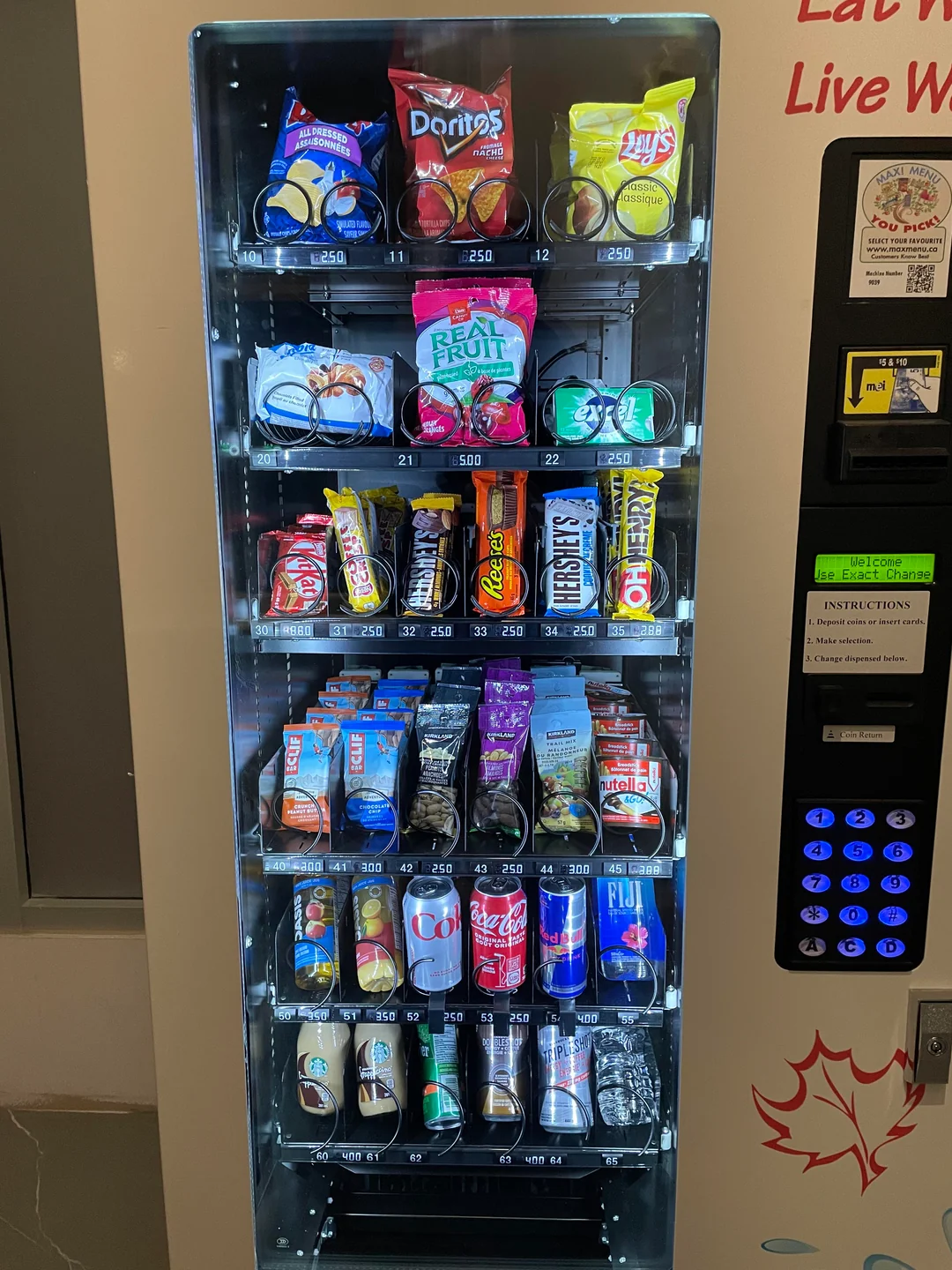 Best snacks for vending machines UK showing a fully stocked vending machine with top selling crisps chocolate bars and drinks organised by category