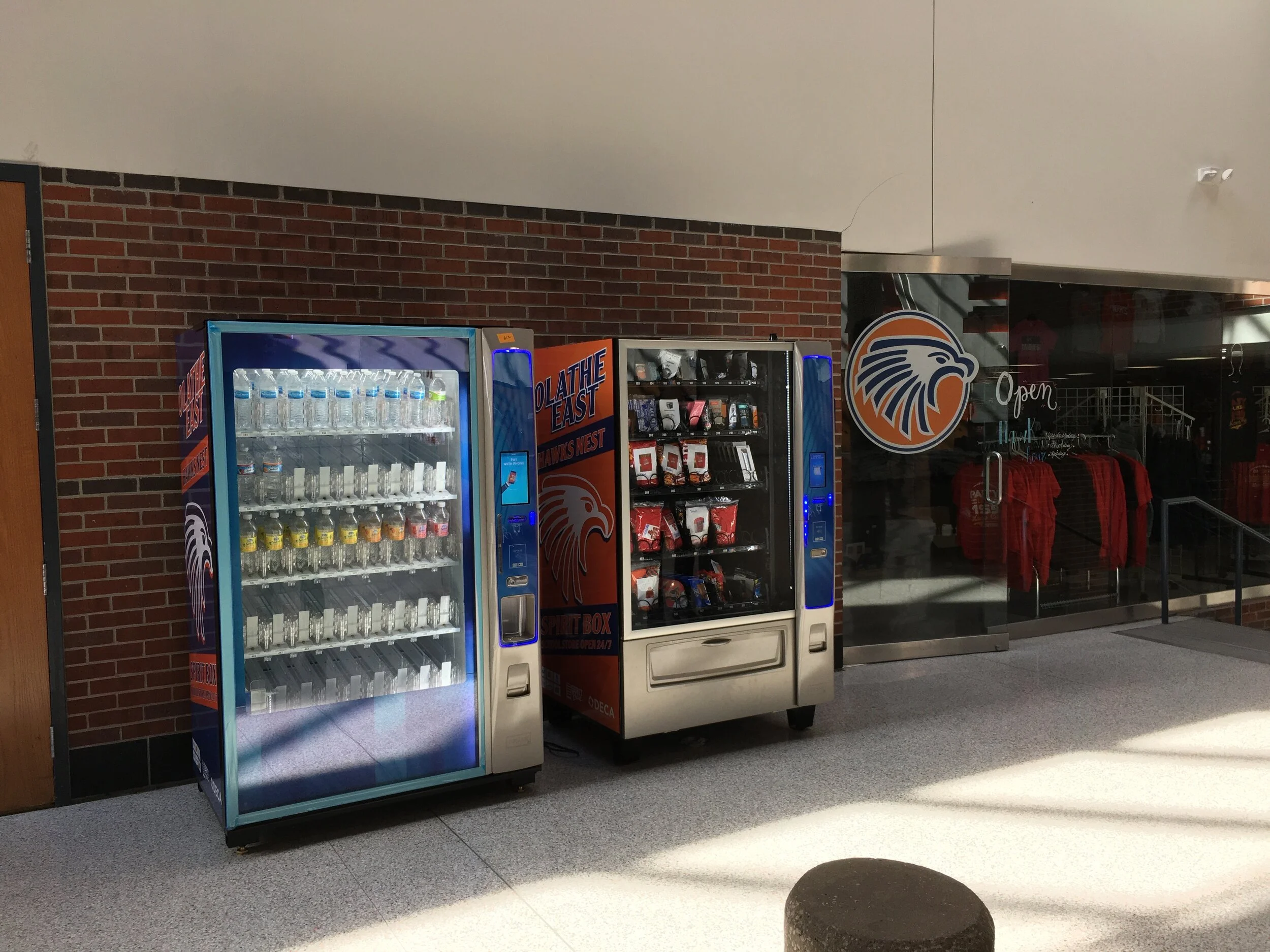 Vending machines for schools with water and healthy snacks in a UK school corridor