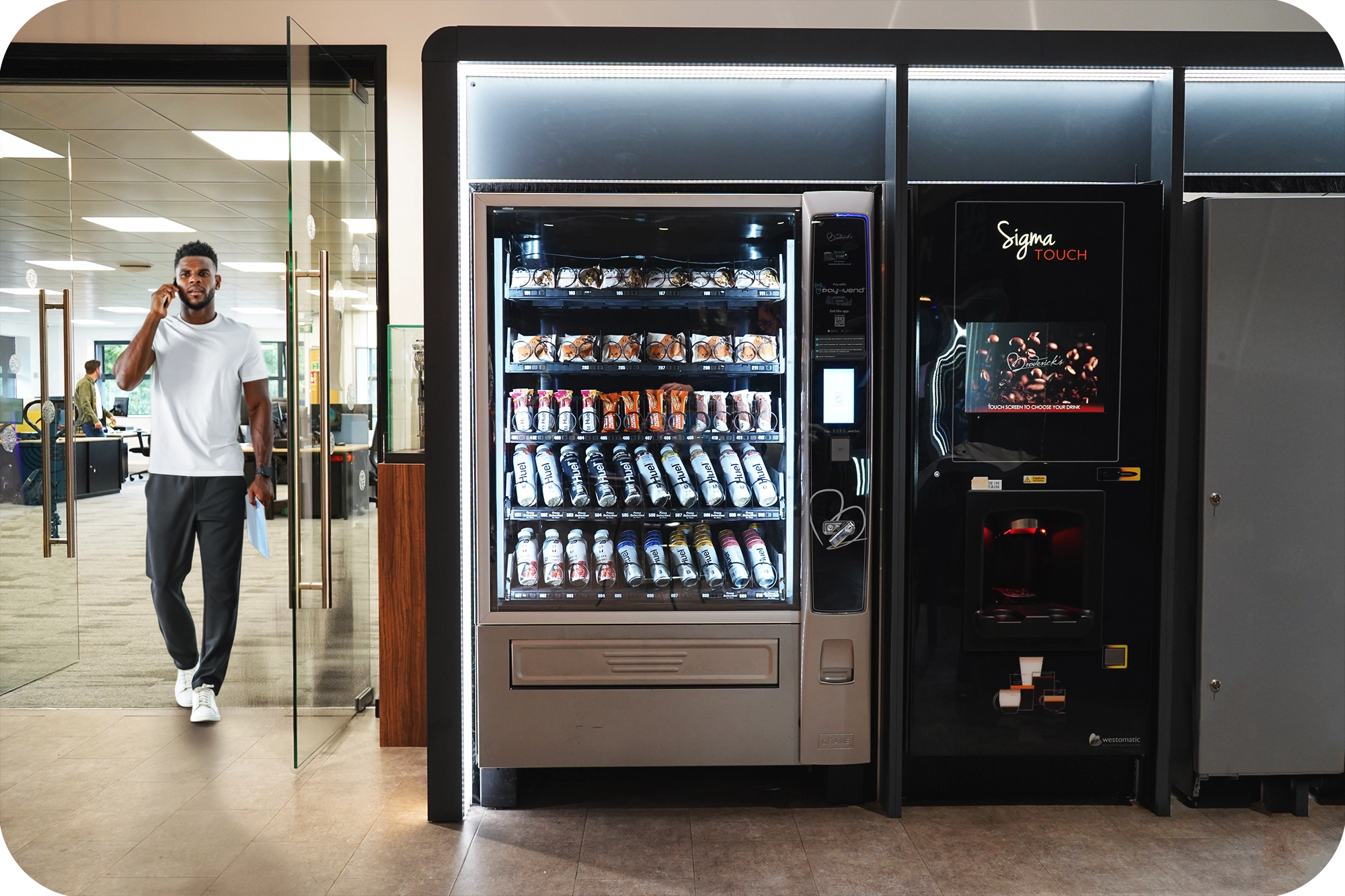 Drinks vending machine stocked with cold cans and bottles in a UK office