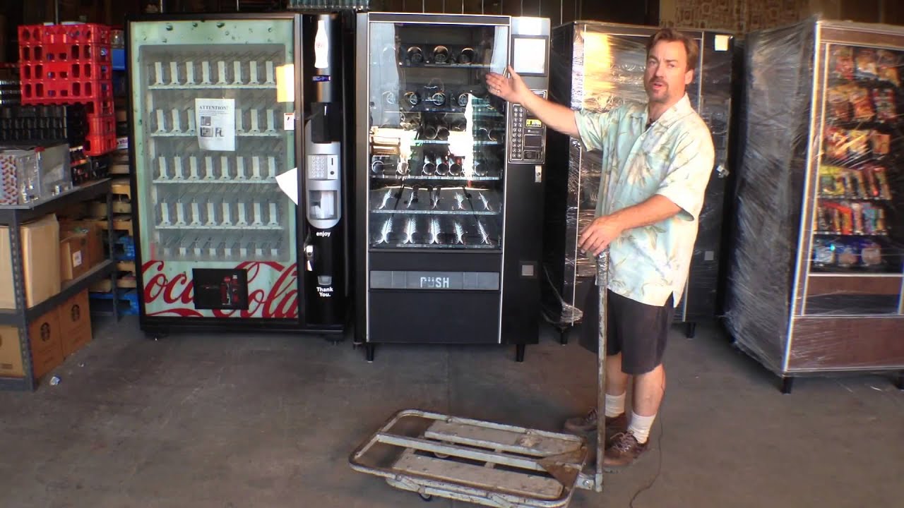 Team using an appliance trolley to move a vending machine safely